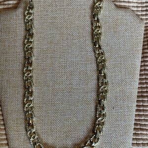 Long vintage gold tone necklace. Unique stirrup type design.